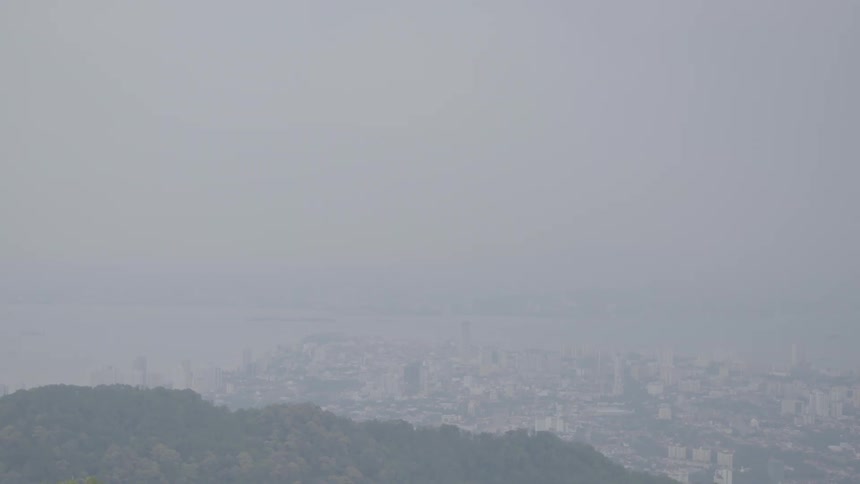 Heavy fog obscures a downtown city along the coast