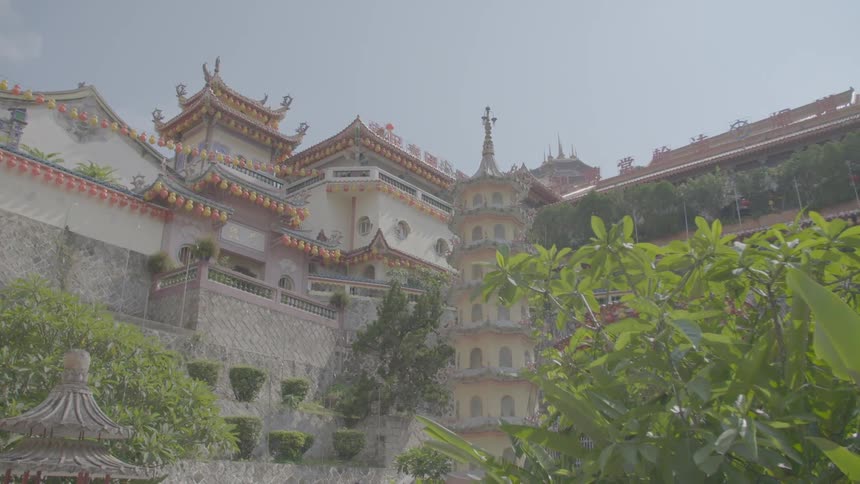 Exterior of large asian style temple with terraces and plants