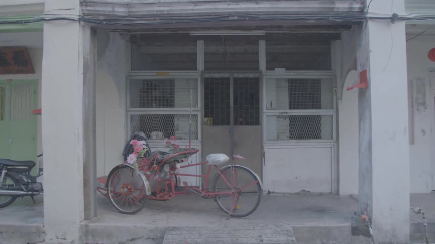 Tricycle parked on the entrance of an old building
