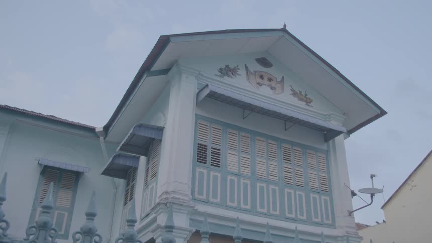 A blue and white house in a residential area