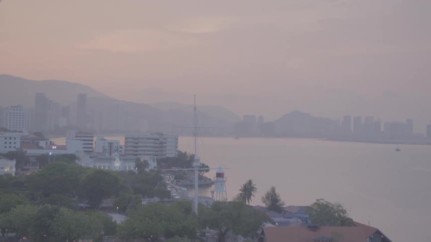 The coastline of a city on a foggy day