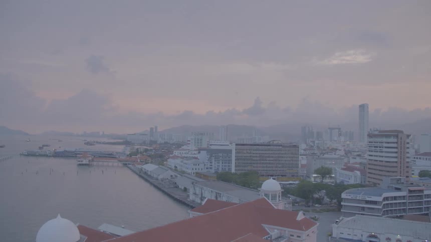 An aerial view of the water coast and buildings in a city