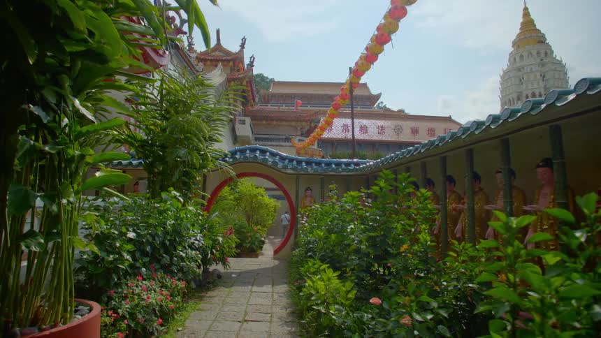 The path leads to the buildings ahead