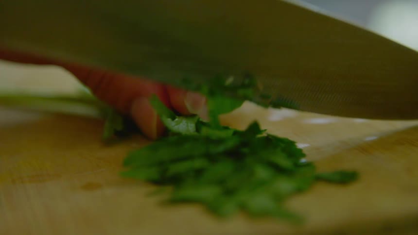 A person chopping herbs