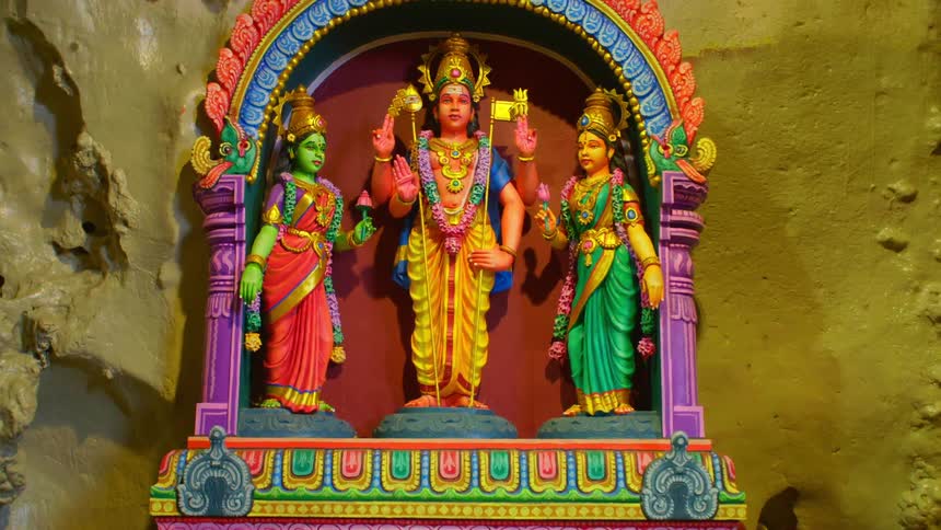 Shrine with colorful statues of hindu deities on the corner of a room