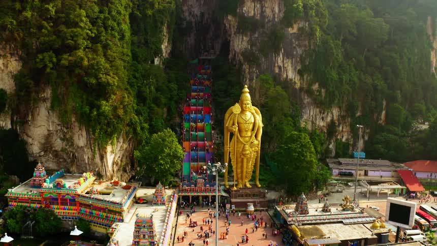 Batu caves temple in malaysia next to the lord murugan statue