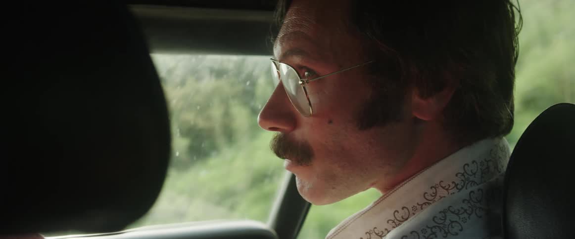 A man is driving a car in spring