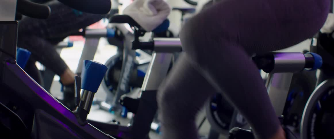 People exercising on spin bikes in a gym