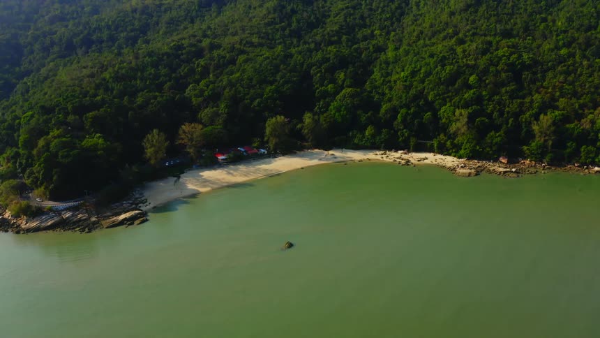 An aerial view of a beach and ocean in the daytime