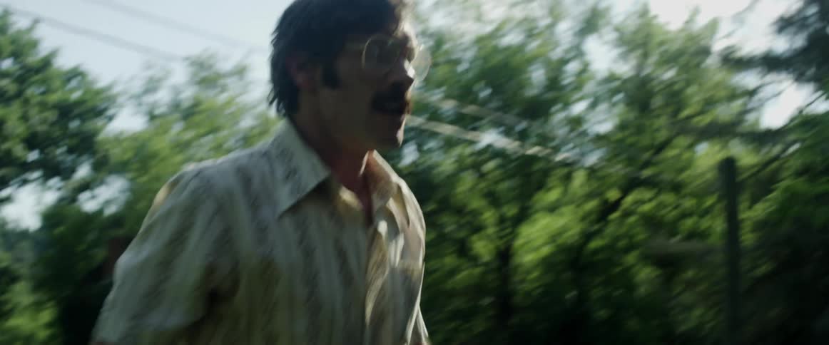 A mustached white male pushes a large white man