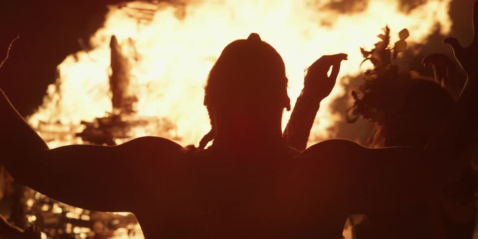 People performing a ritual around a fire