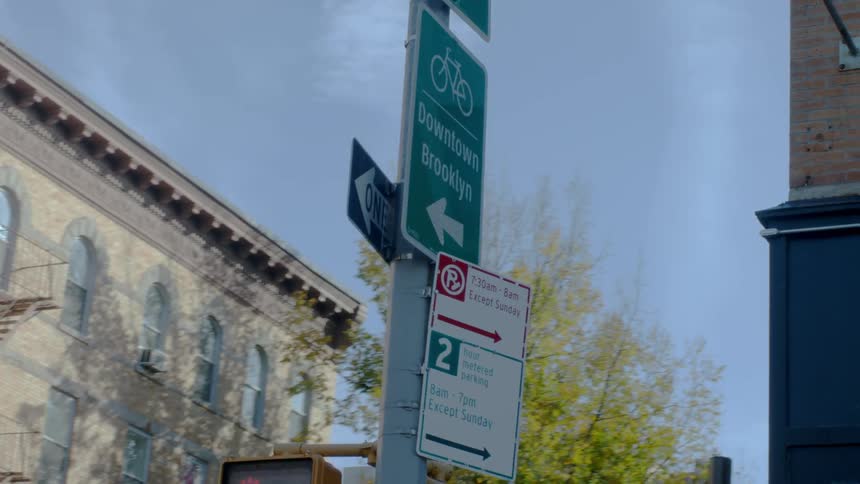 Passing by a street sign on the corner of a street