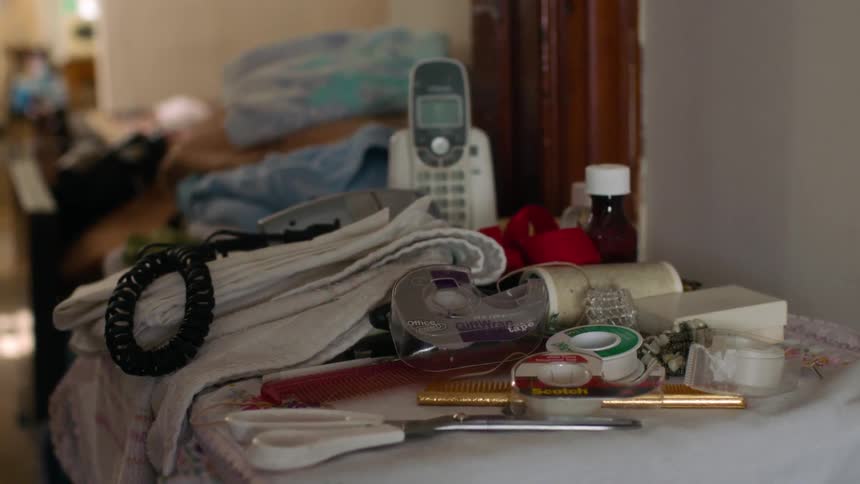 A phone is sitting on a messy counter