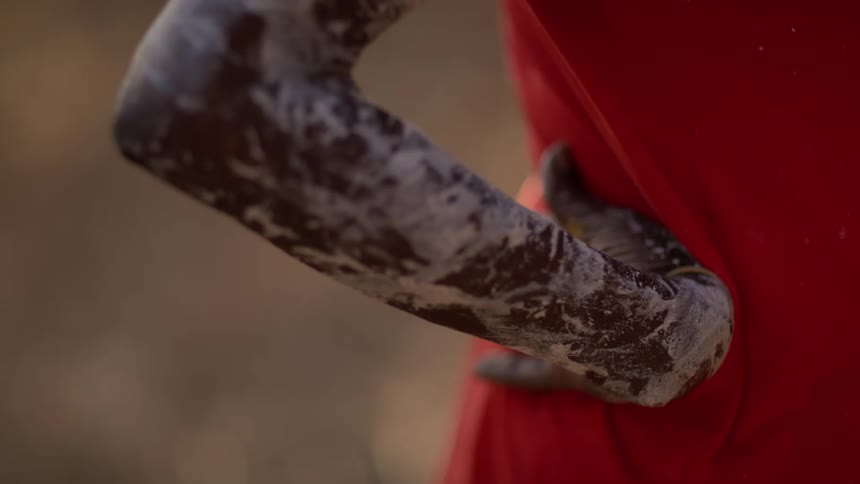 A person with white paint on their arm