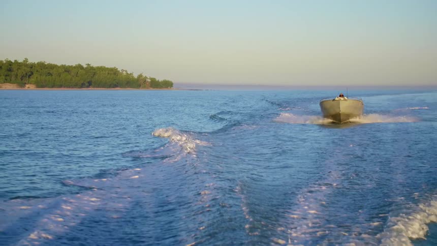 A boat bounces on the waves as it travels in the ocean off the coast of Australia