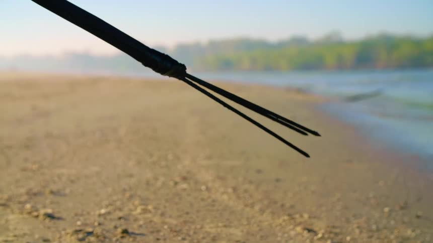 Three pronged spear is covered along beach
