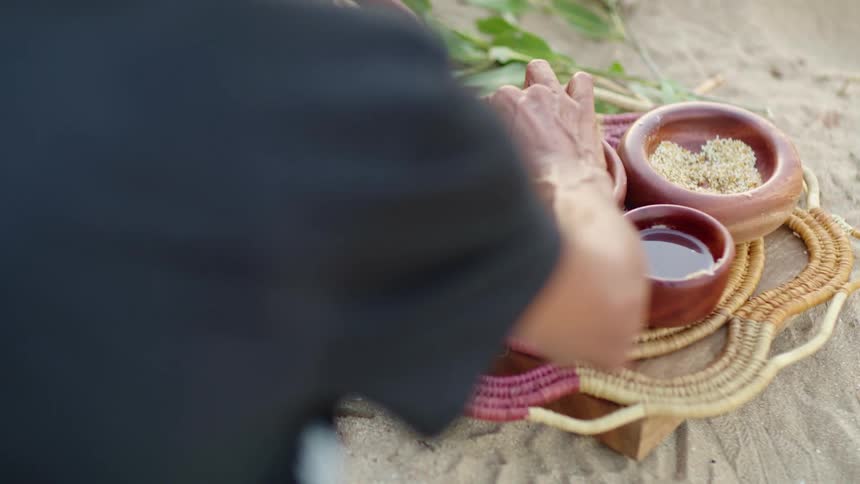 People eating damper on the beach