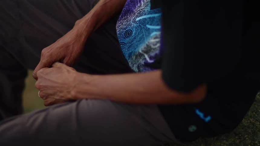 Close up of a woman's hands in her lap as she sits