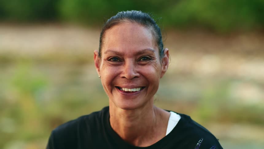 A woman smiling standing outdoors