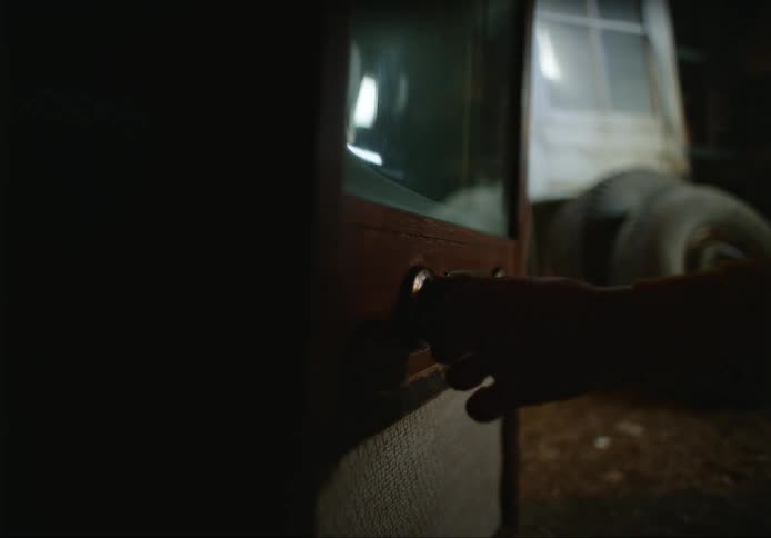 A person turning a dial on an old television at home