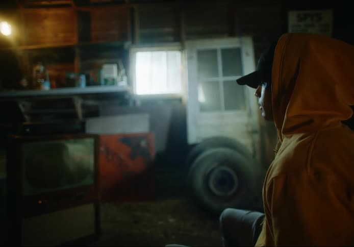 A man sitting in a chair in a garage rocking