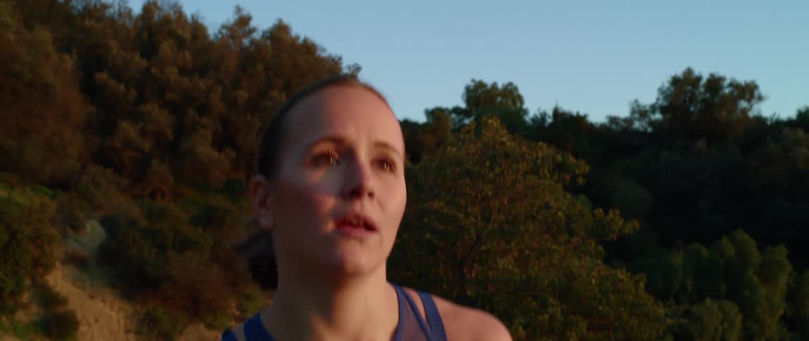 A woman running on a trail