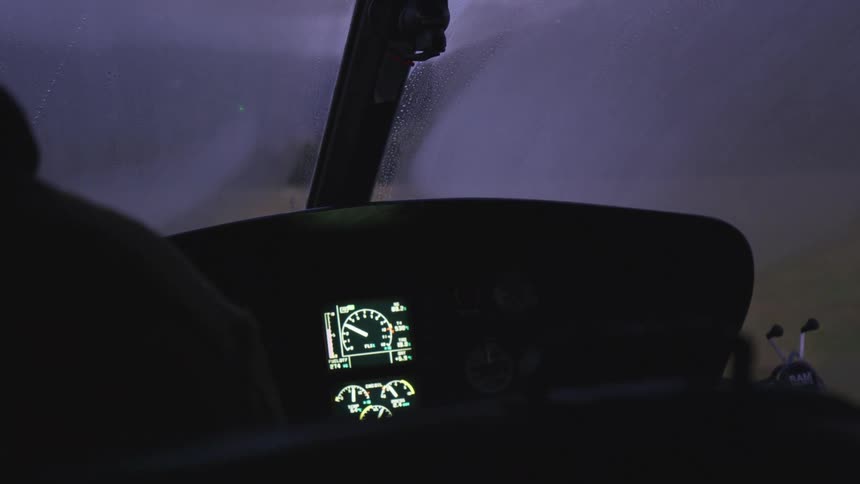 A person presses a switch in the cockpit