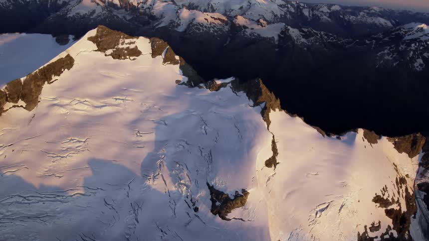 An aerial view of a snow covered mountain range