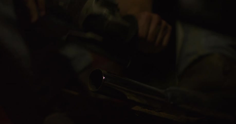 A worker is grinding metal with an angle grinder