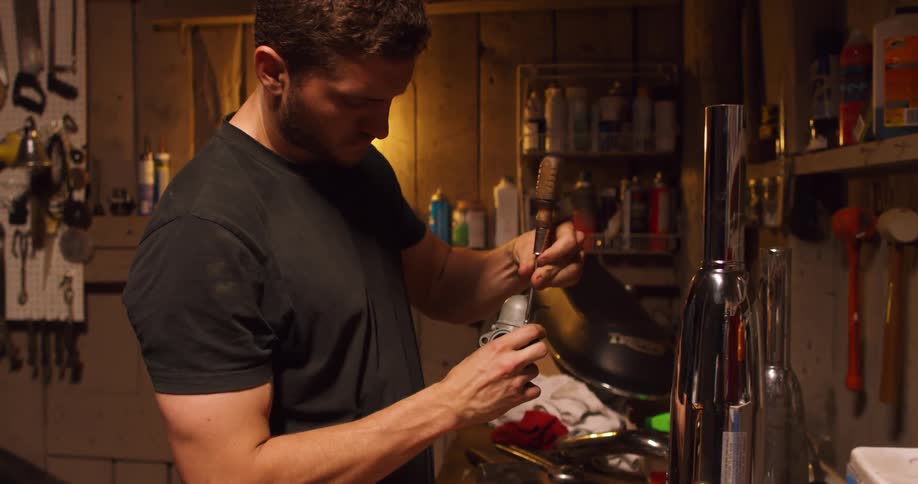 A man working at a workbench with tools