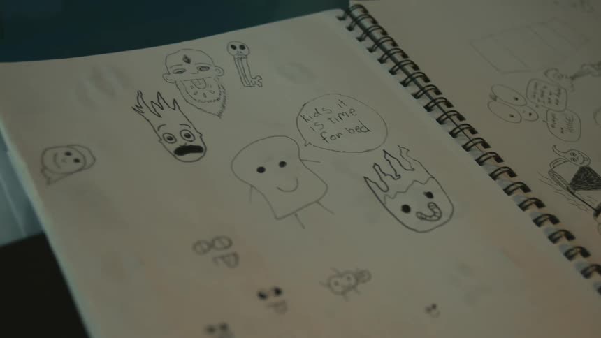 A notebook with doodles and drawings in it