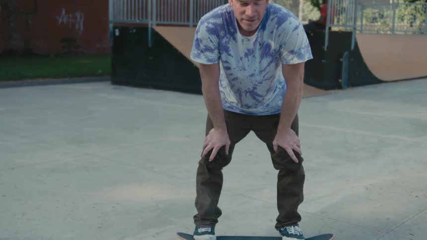Man rides skateboard at skate park
