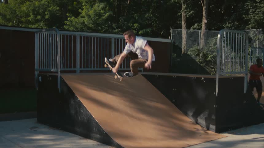 A man rides his skateboard on the ramp