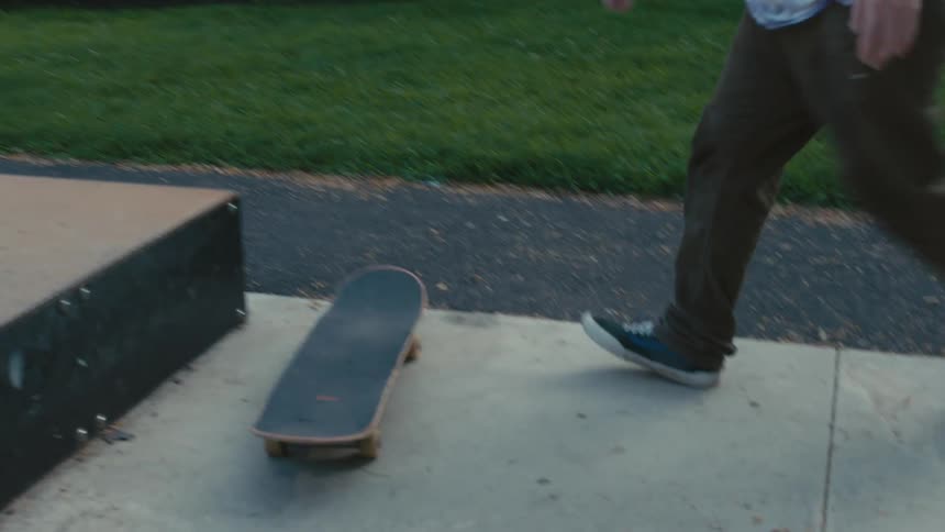 A man does a jump in a skate park
