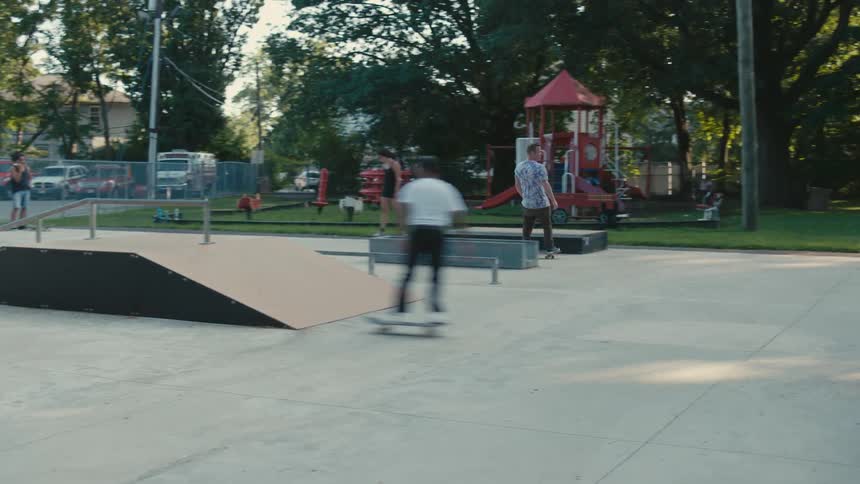 A group of people riding skateboards at a skate park