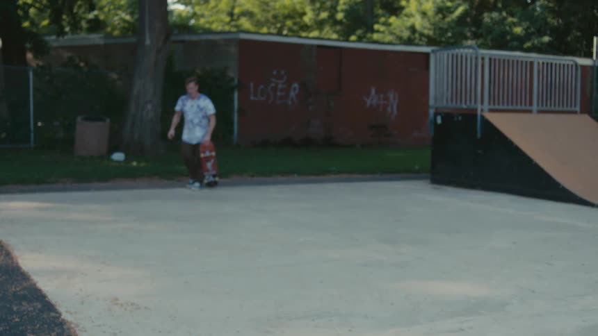 A man misses a jump on his skateboard
