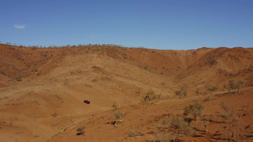 A vehicle driving off road in a sandy area