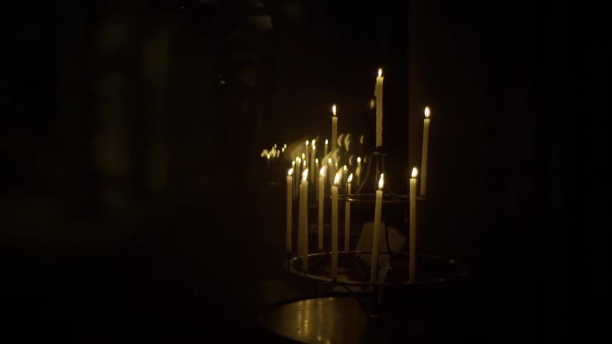 Candles burn in the dark