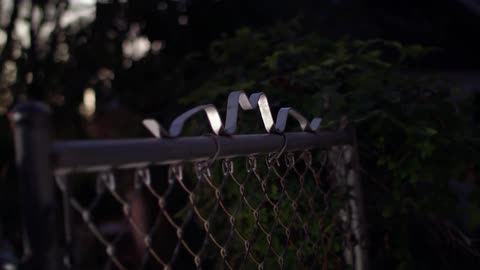 A chain link fence in front of a home