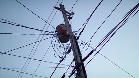 Telephone pole with many wires and transformer
