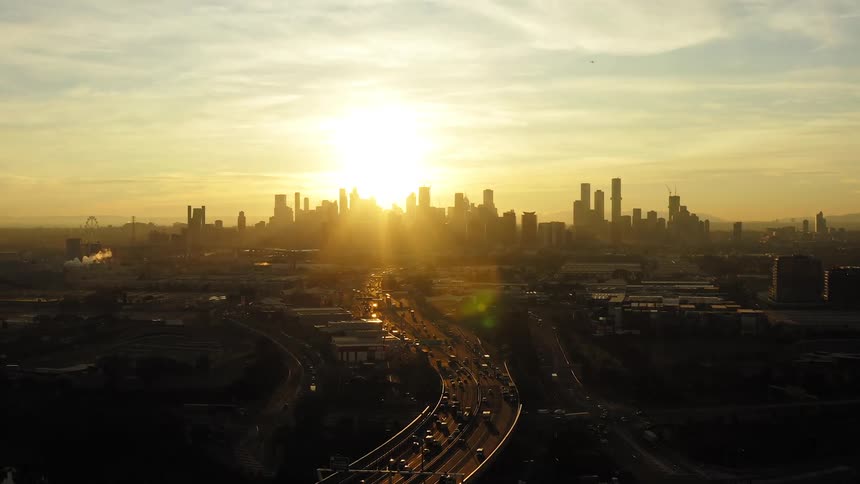 Aerial view of a downtown city at dusk is displayed