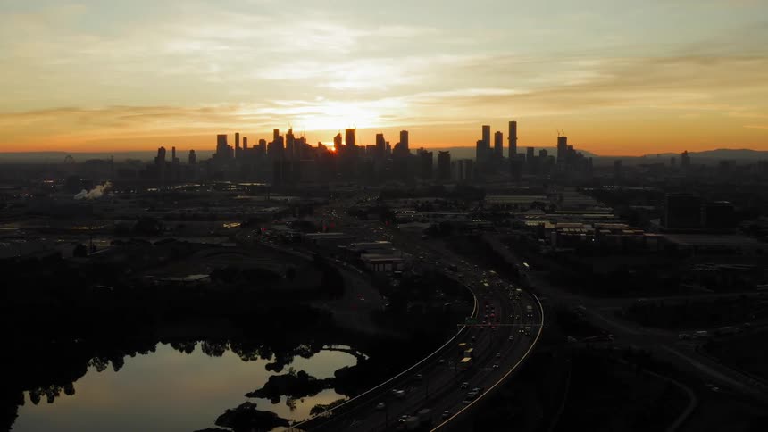 An urban skyline is displayed at dusk