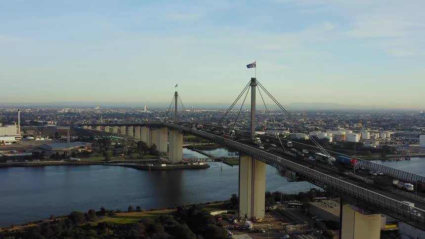 People are traveling on the large bridge in the city