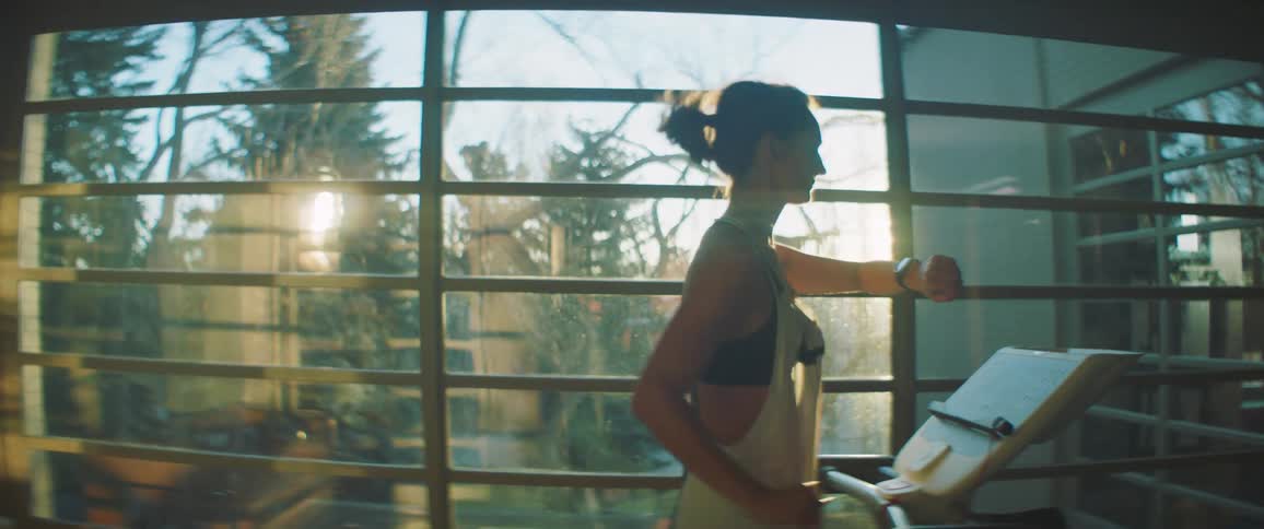 A woman is working out on the treadmill