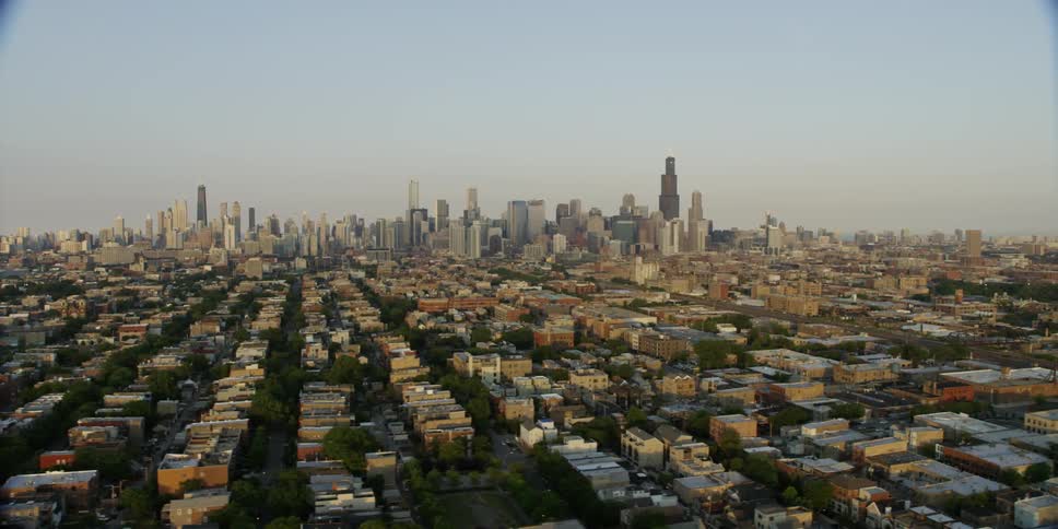 Aerial view of some homes before a large city