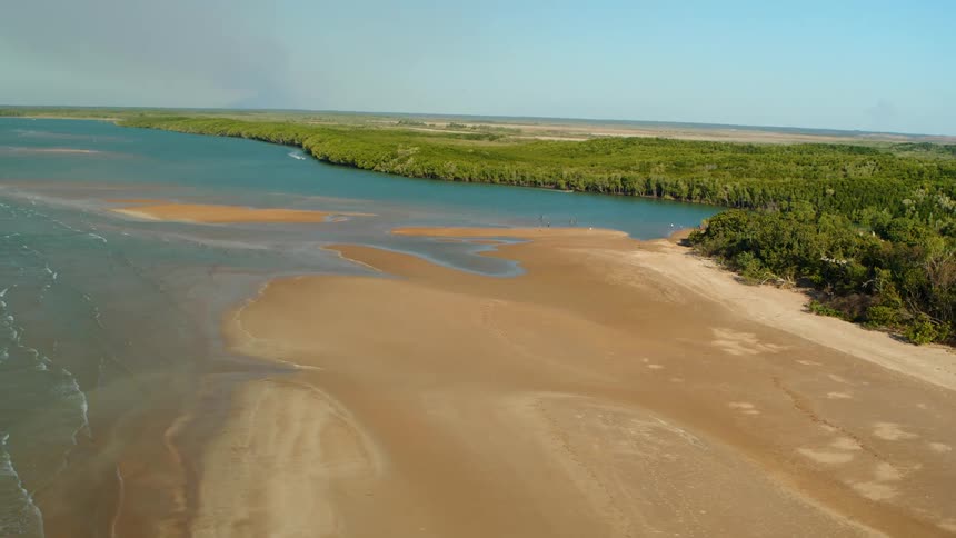 The clear water lines the island