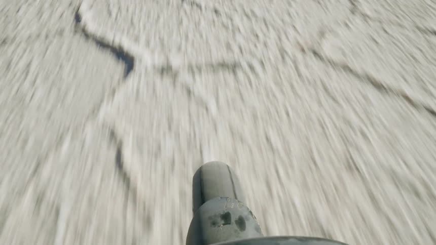 View of a tire on a motorcycle as it drives across terrain