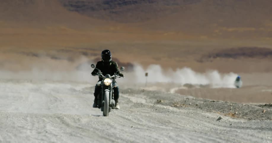 Motorcycles are giving off dust clouds as they ride