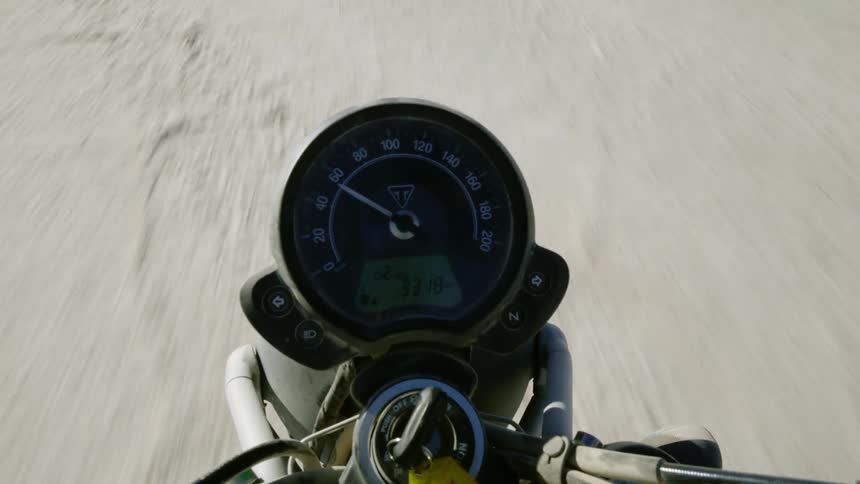 A speedometer on a motorcycle as it is being driven