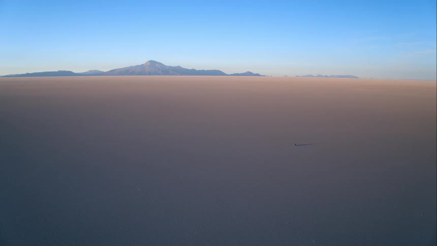 A person is walking through the desert